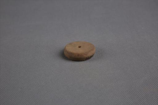 商圆饼形中穿夹砂黄褐陶纺轮
