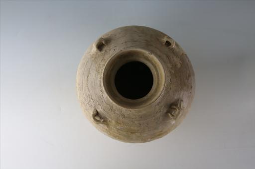 六朝盘口束颈弧肩鼓腹平底桥形耳凹弦纹青釉瓷罐