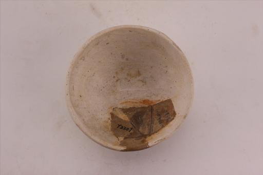 新石器时代城背溪文化侈口弧腹饼底泥质红褐陶碗